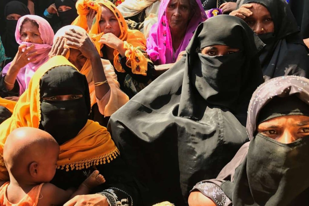 Rohingya refugee women wait to collect relief vouchers at Kutupalang Unregistered Refugee Camp in Cox's Bazar, Bangladesh. Photo: Reuters