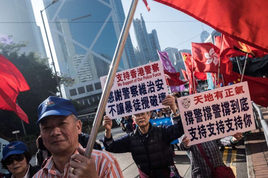 Supporters of the seven police officers, who were jailed for assaulting activist Ken Tsang, marched in Central during a rally in Hong Kong. Photo: AFP