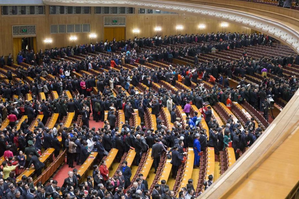 Deputies attending China's 12th National People's Congress leave after the closing meeting of the fifth session at the Great Hall of the People in Beijing on Wednesday. Photo: Xinhua