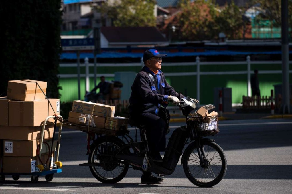 A man delivers parcels ordered online in Shanghai. Photo: AFP