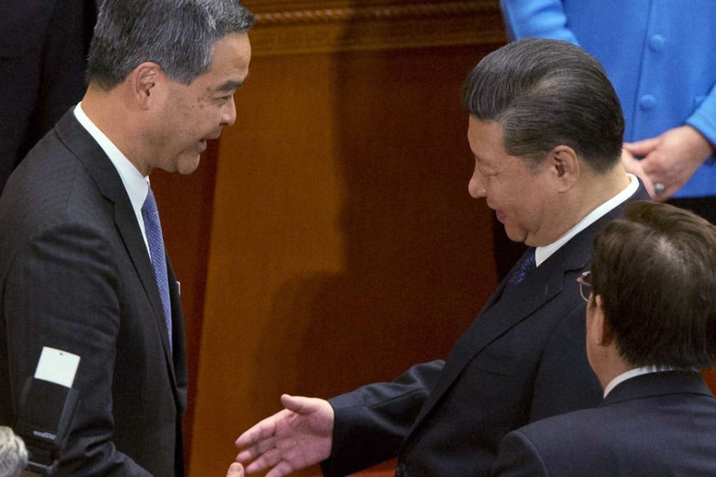 Chief Executive Leung Chun-ying interacts with President Xi Jinping in a handshake and a 45-second chat. Photo: AP/Ng Han Guan