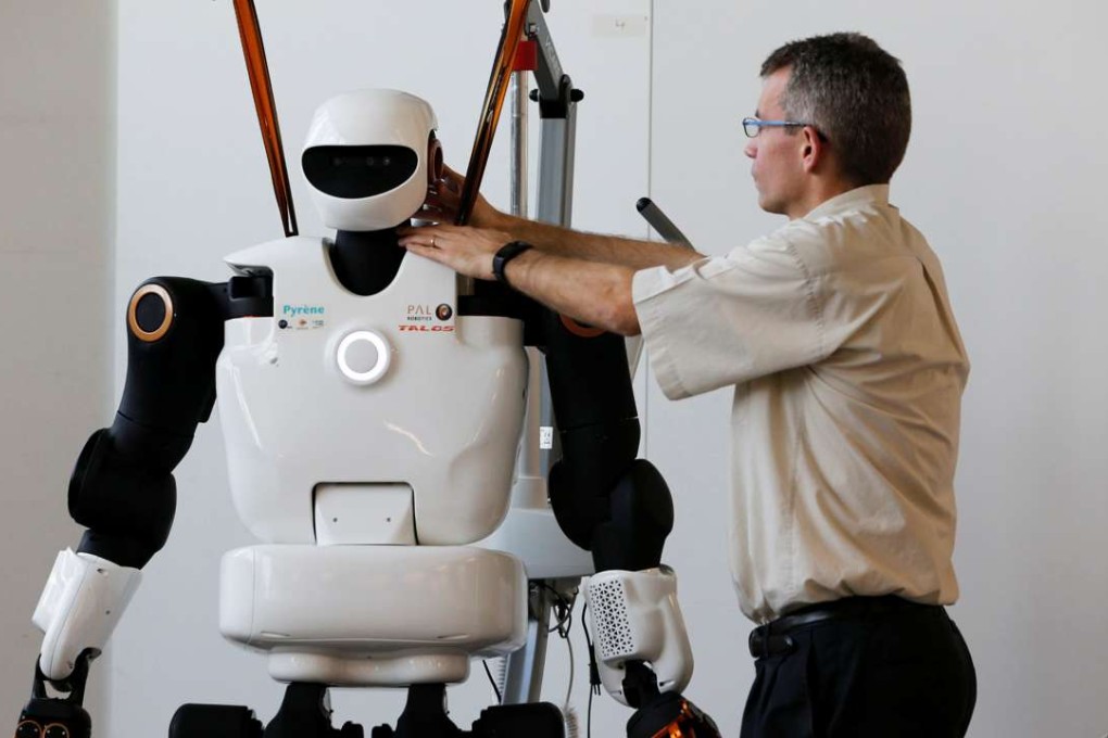 Olivier Stasse, Head of Research at CNRS, tests Pyrene, a humanoid robot handyman, developed by a French lab in Toulouse, France, on February 21. Photo: Reuters