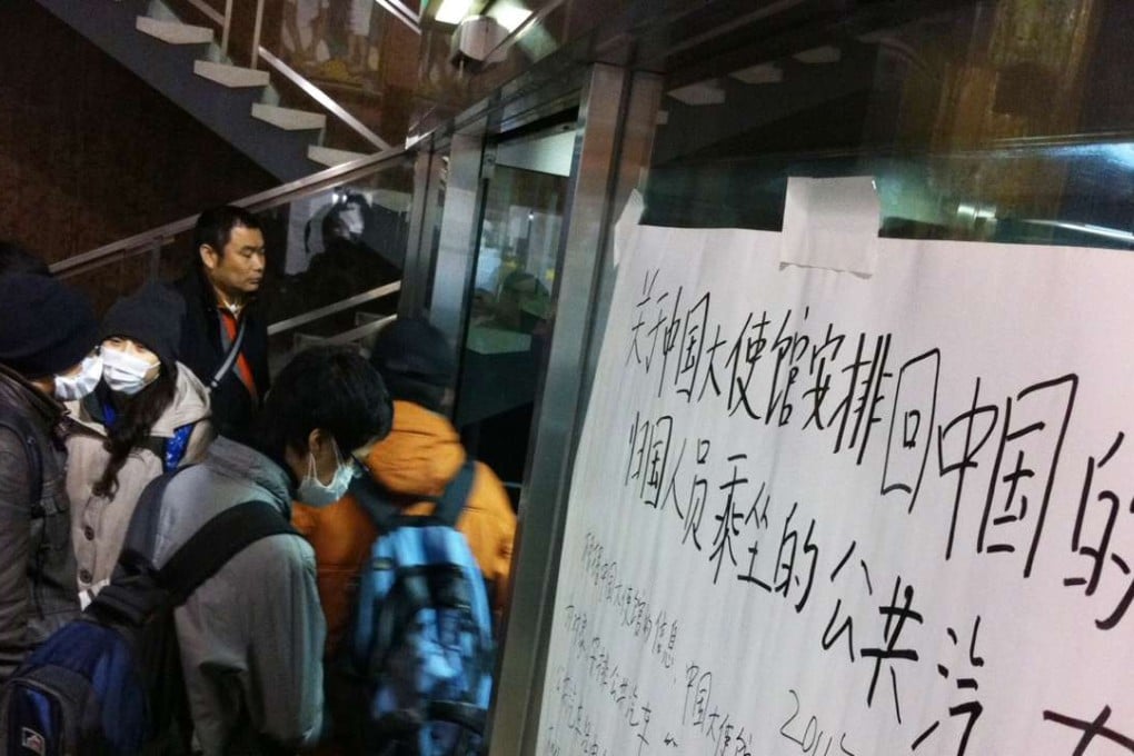 Chinese nationals wait to take buses provided by the Chinese embassy to be evacuated from the devastated city of Sendai, Miyagi prefecture after the 2011 earthquake and tsunami disasters. File photo: AFP