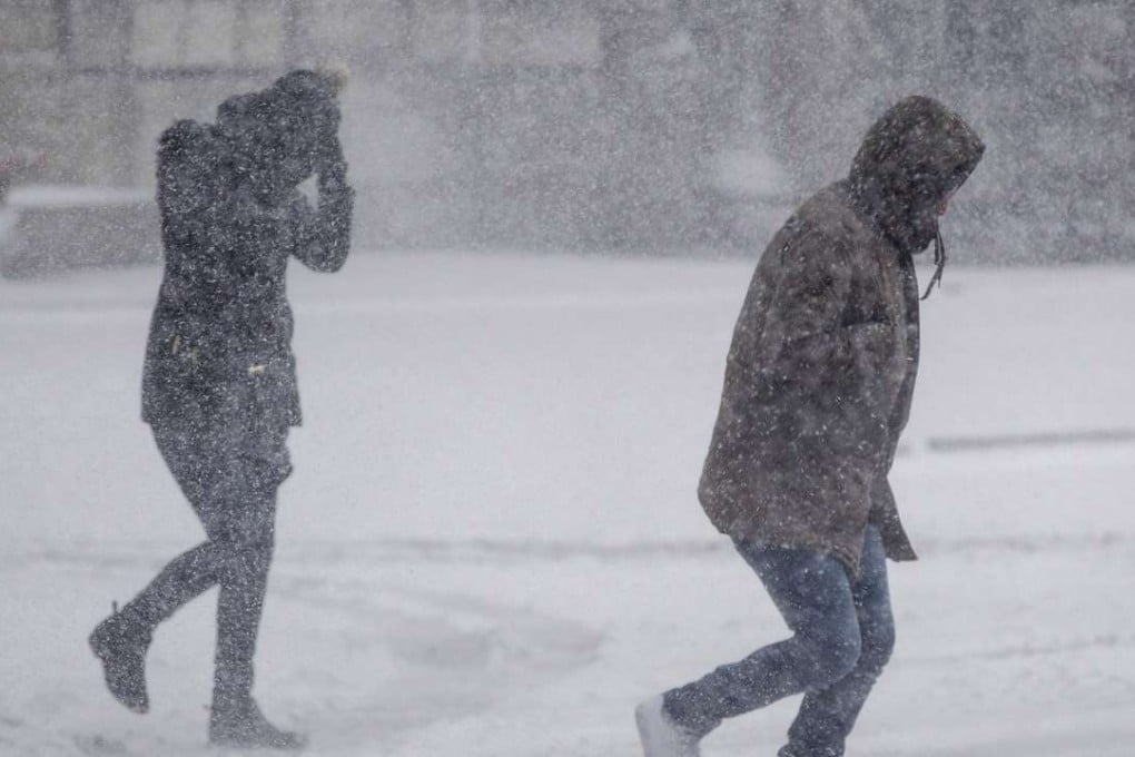 Pedestrians struggle to cross a street during white out conditions and high winds as Winter Storm Stella bears down on Boston, Massachussets, on Tuesday. Photo: AFP