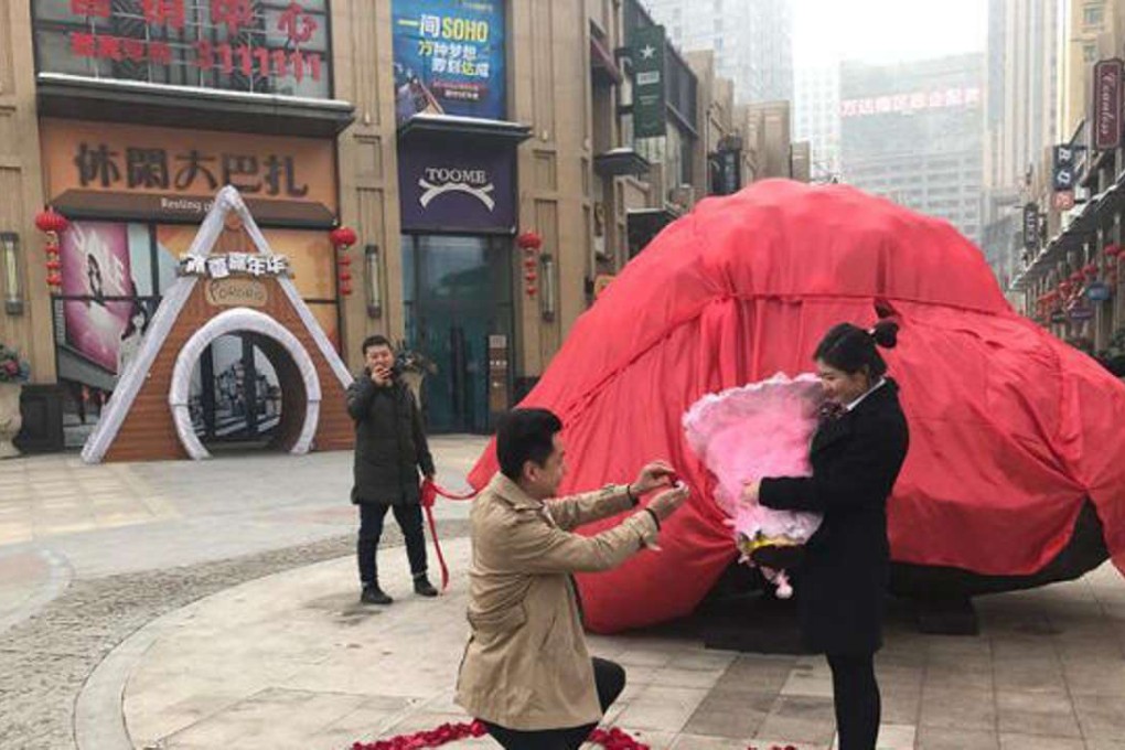 Liu Fei kneels before girlfriend Wang Fangfang - and the 33 tonne space rock. Photo: Handout