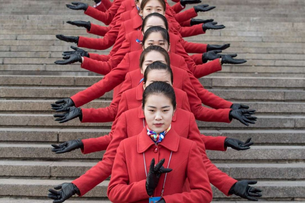 Hostesses pose during the opening session of the Chinese People's Political Consultative Conference (CPPCC) in the Great Hall of the People in Beijing. Photo: AFP