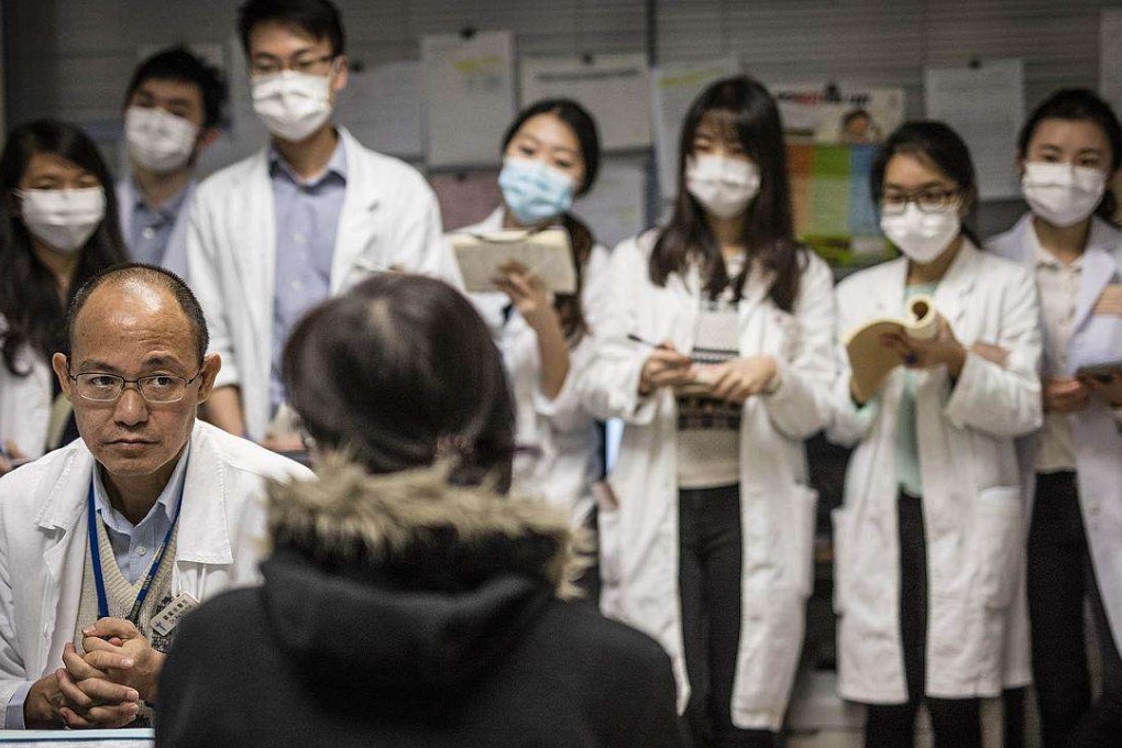 An image taken by Ducky Tse shows Dr Au Yiu-kai with a patient, part of the “130 Years of Medicine in Hong Kong” exhibition