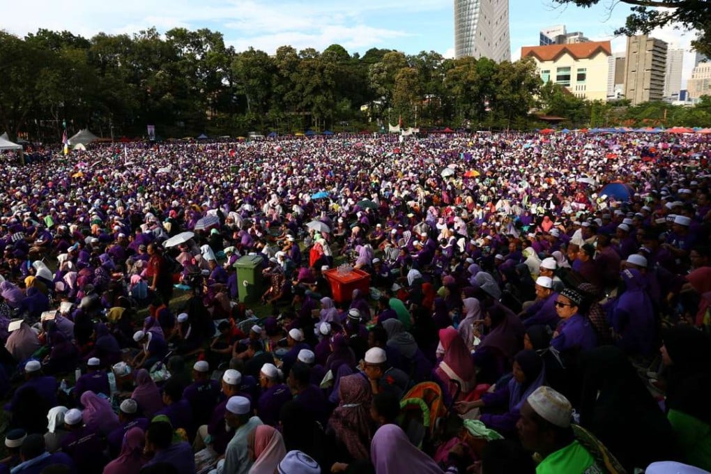 A rally in Kuala Lumpur calls for elements of a strict Islamic penal code to be adopted. Photo: Reuters