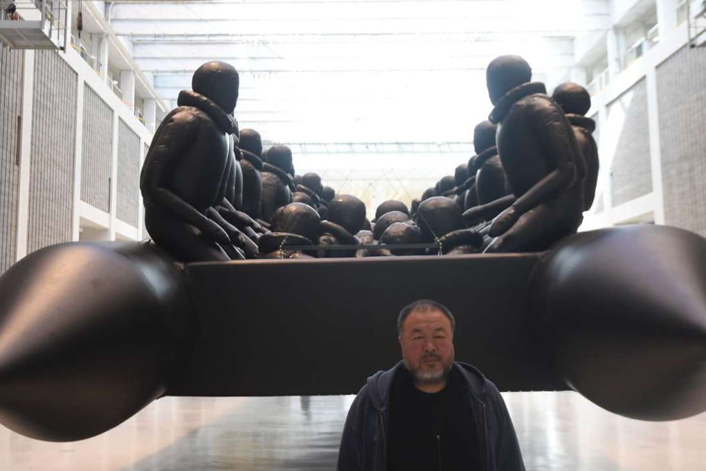 Chinese conceptual artist and political activist Ai Weiwei poses for photographers in front of his new instalation, Law of the Journey, at the National Gallery in Prague. Photo: AFP