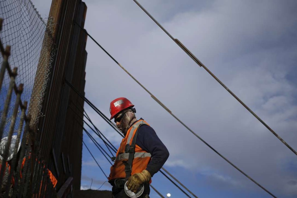 Contractors work on a new section of a border fence separating the US and Mexico in Sunland Park, New Mexico, last month. Photo: Bloomberg