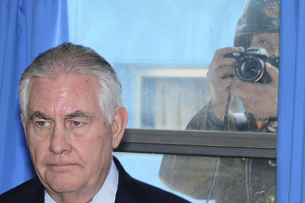 A North Korean soldier takes a picture of US Secretary of State Rex Tillerson from outside the window during his visit to Panmunjom, the truce village near the inter-Korean border, South Korea, on Friday. Tillerson heads to China on Saturday. Photo: EPA