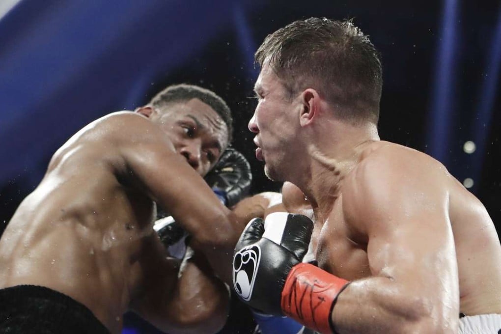 Daniel Jacobs punches Gennady Golovkin during the first round of their middleweight title fight in New York. Photo: AP