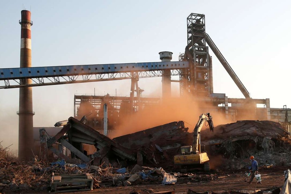 Workers demolish a steel plant in Hangzhou in Zhejiang province as part of efforts to curb pollution in the area. Photo: Reuters