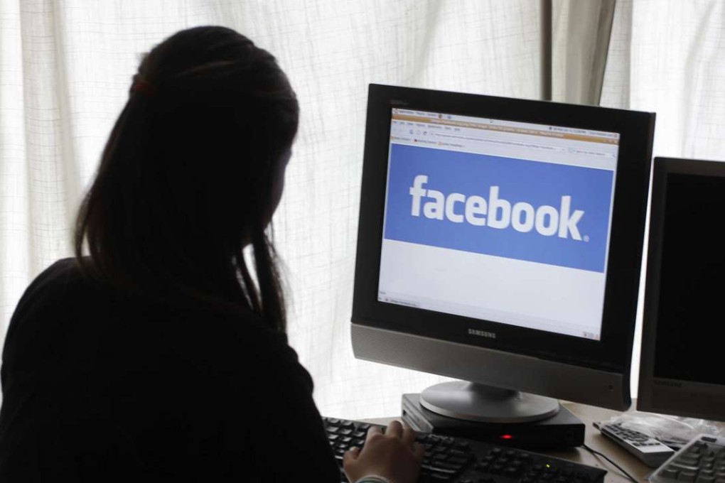 A girl looks at Facebook on her computer in Palo Alto, California. Facebook, Google and big media companies are trying to clamp down on the spread of false stories. Photo: AP