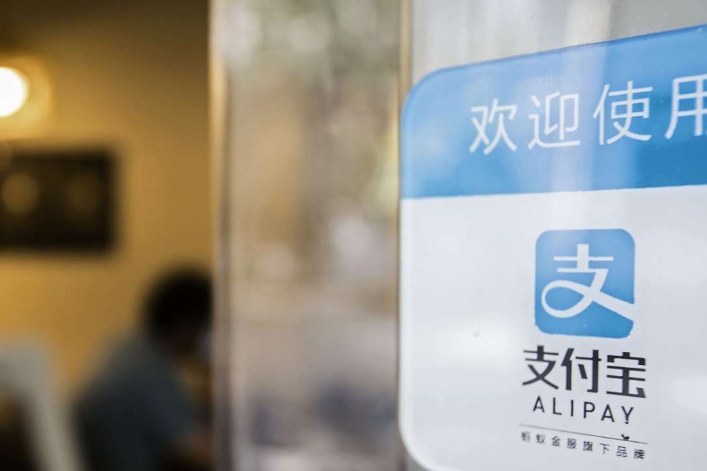 Signage for Ant Financial Services Group's Alipay payment system, an affiliate of Alibaba Group Holding Ltd., is displayed on a store entrance in Shanghai. Photo: Bloomberg