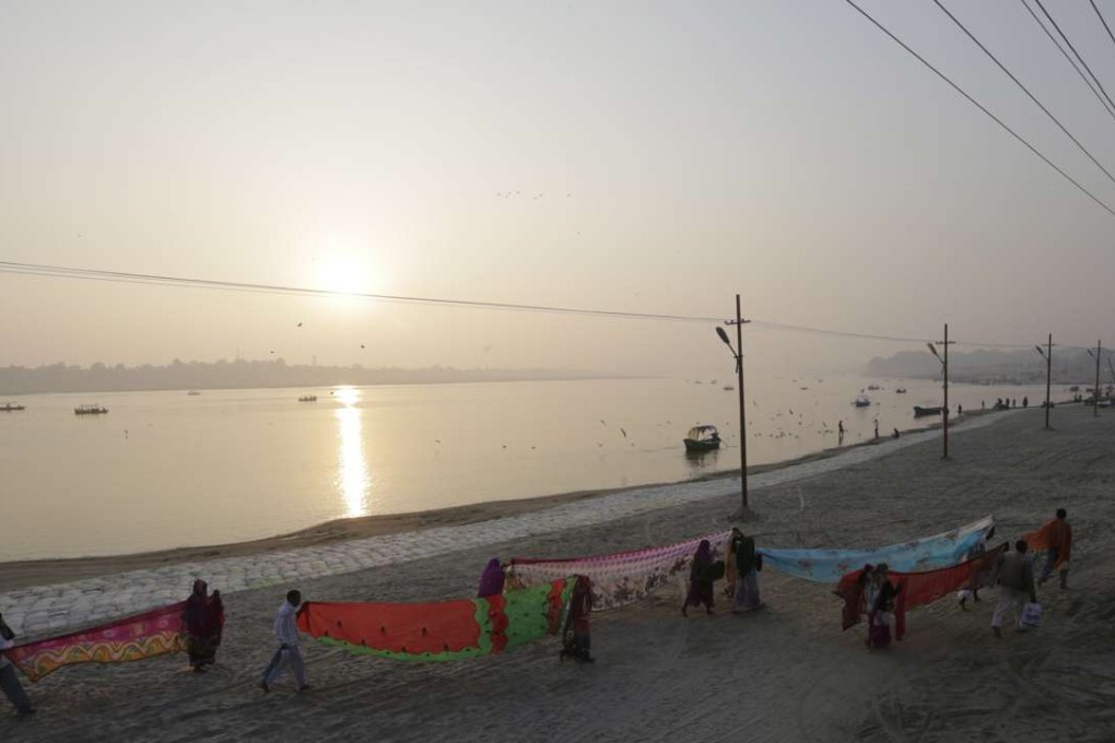 Hindu devotees dry their clothes after taking a dip at Sangam, the confluence of rivers Ganges, Yamuna, and mythical Saraswati in Allahabad, India. Photo: AP