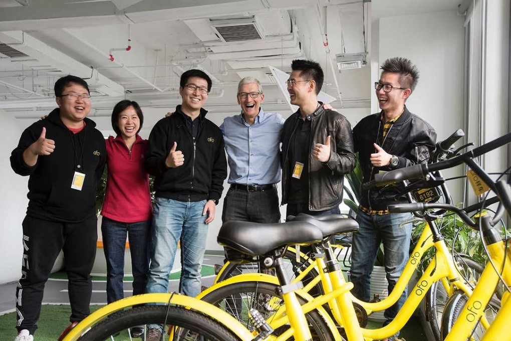 Apple chief executive Tim Cook (centre) during his visit on Tuesday to the offices of bike-sharing start-up Ofo in Beijing. - Photo: SCMP Handout