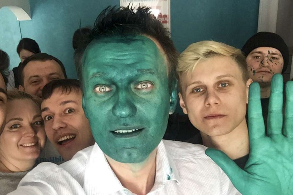 Russian opposition leader Alexei Navalny takes a selfie with supporters after an unknown assailant sprayed a bright green antiseptic stain on his face in a city of Barnaul, Russia on Monday. Photo: AP
