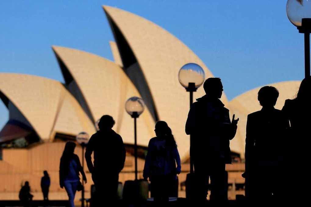 People are silhouetted against the Sydney Opera House at sunset in Australia. Australia has seen continuous growth since 1990, and the economy has greatly changed. The service sector comprises close to 80 per cent of GDP today, compared to around 60 per cent at the time of “Brentry”, while manufacturing employment has dropped from about 25 per cent to 10 per cent. Photo: Reuters