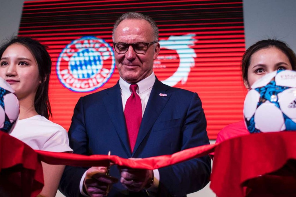Chief executive officer Karl Heinz Rummenigge cuts the ribbon during the opening ceremony of Bayern Munich’s first China office in Shanghai. Photos: AFP
