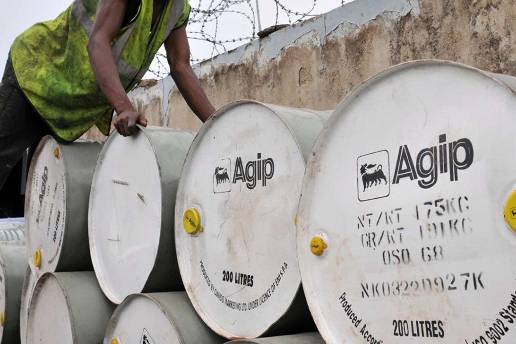 A worker arranges drums at an oil station and depot in Nigeria's capital Abuja. Photo: Reuters