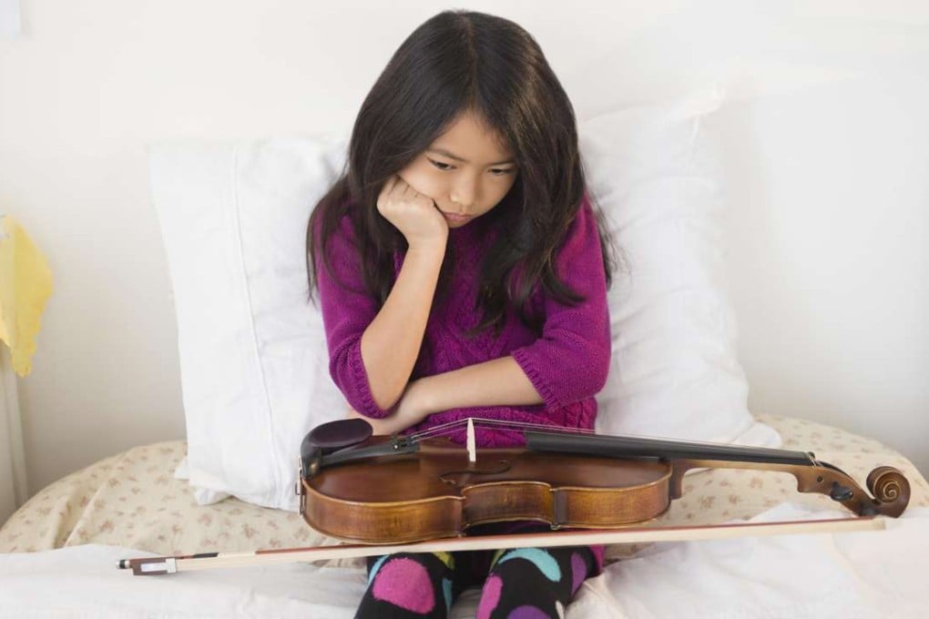 This budding violin virtuoso is lacking motivation to practise. Photo: Alamy