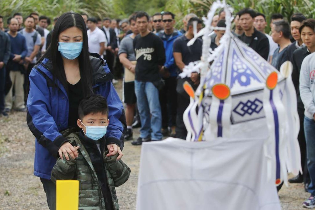 Late fireman Yau Siu-ming's wife and his son attend the memorial ceremony in Ma On Shan. Photo: Sam Tsang