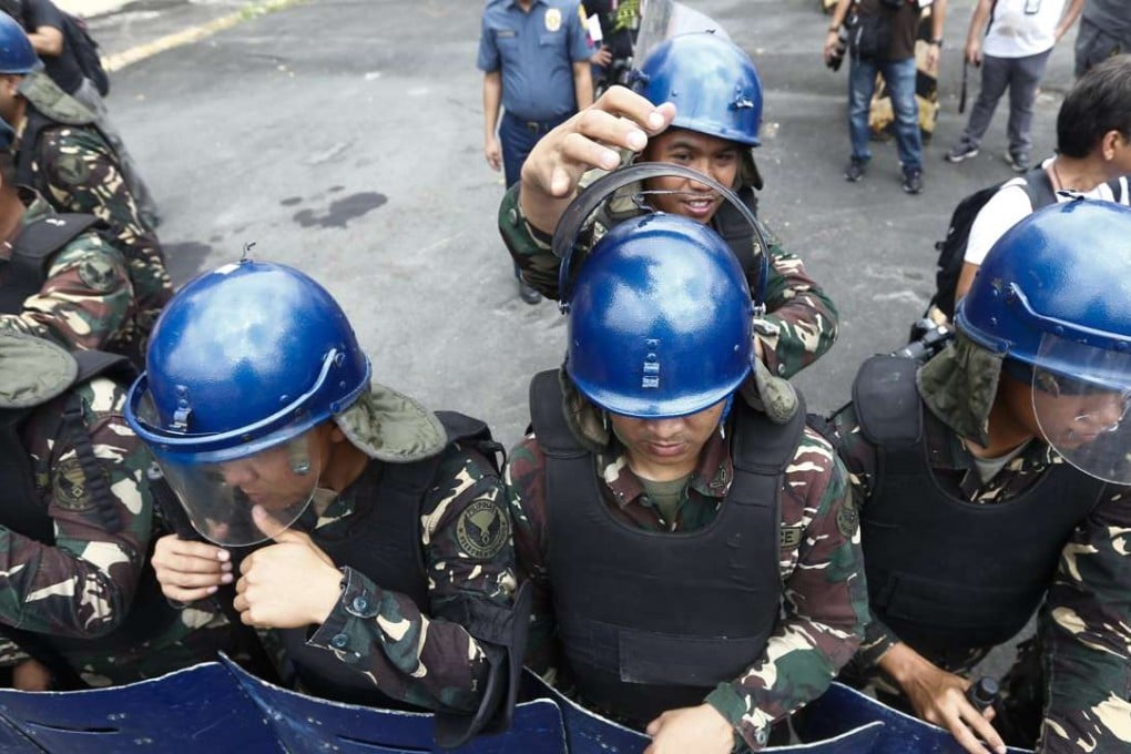 Philippine anti-riot soldiers get ready for a protest. President Rodrigo Duterte warned Thursday he may impose martial law and suspend elections for tens of thousands of local posts, fuelling concerns about democracy under his rule. Photo: EPA