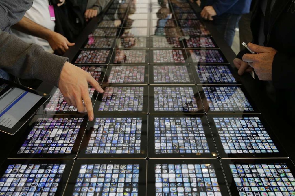 Developers look over new apps being displayed on iPads at the Apple Worldwide Developers Conference in San Francisco. A new app can soon test the fertility of men’s sperm. Photo: AP