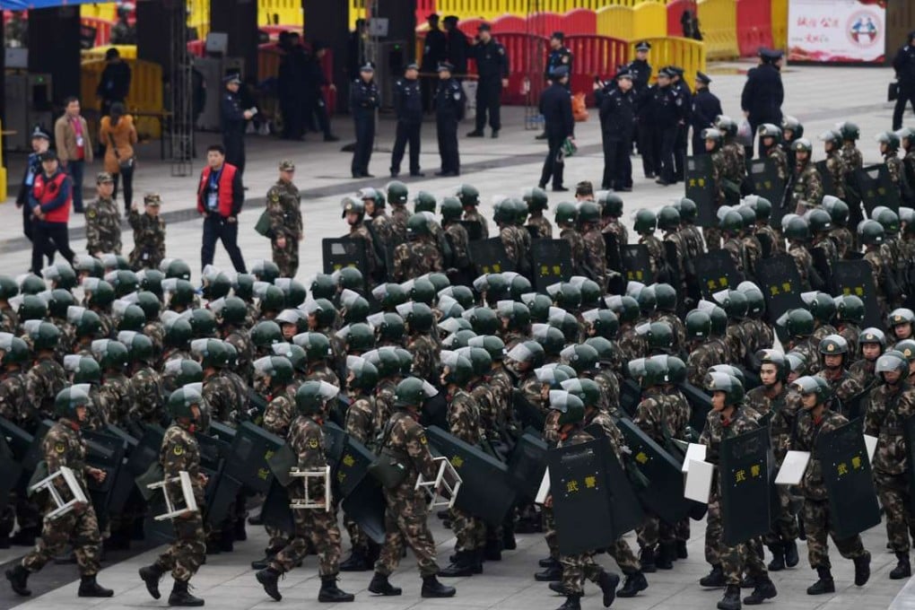 Paramilitary police gather outside the Helong stadium ahead of the World Cup football qualifying match between China and South Korea in Changsha, Hunan province, on Thursday. Photo: AFP
