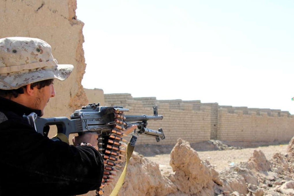 An Afghan border police takes position following an operation by International and Afghan troops to re-take control from Taliban militants in Bulan village, Lashkargah city, the capital city of Helmand province, Afghanistan. Photo: EPA