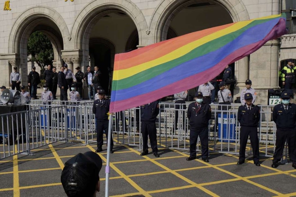 A supporter of same-sex marriage waves a rainbow flag outside the Judicial Yuan in Taipei on Friday. Photo: AFP