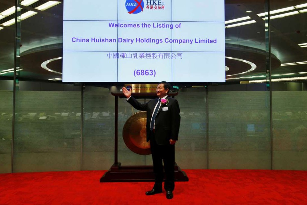 Yang Kai, chairman and CEO of China Huishan Dairy, during the company’s listing debut in Hong Kong on September 27, 2013. Photo: Reuters
