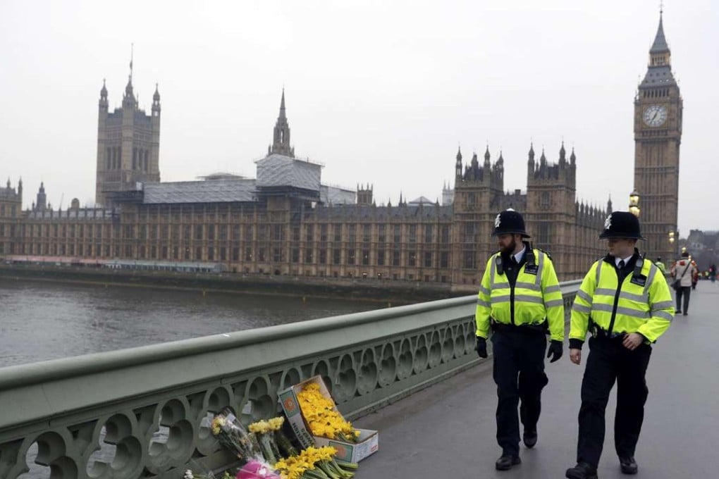 Flowers are placed at the scene of an attack on Westminster Bridge, in London. Photo: Reuters
