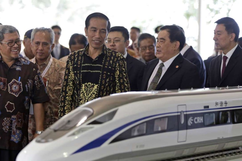 Indonesian President Joko Widodo, centre, last year inspects a model of the high-speed train that will connect Jakarta Bandung. Photo: AP