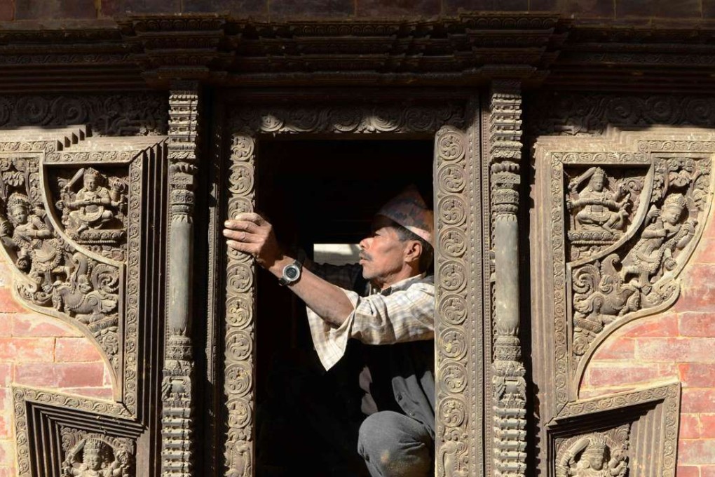 A worker renovates a heritage site at Durbar Square in Kathmandu. Photo: AFP