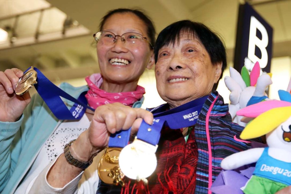 Nonagenarian Cheung Suet-ling (right) proudly displays her two gold medals with daughter Lai Yin-mei. Photo: Nora Tam