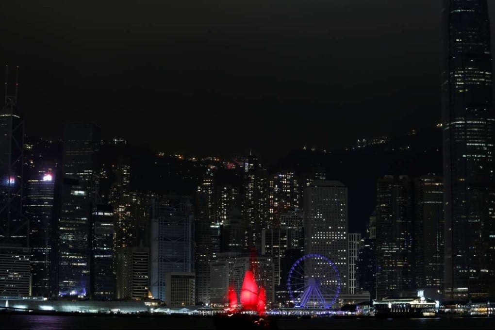 A tourist junk sails past as most of the lights in buildings in the financial Central District are switched off during Earth Hour in Hong Kong. Photo: Reuters