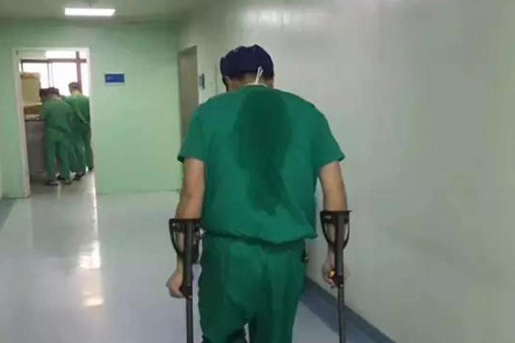 Dr Chen performed two operations with his own leg bound in a splint. Photo: Handout