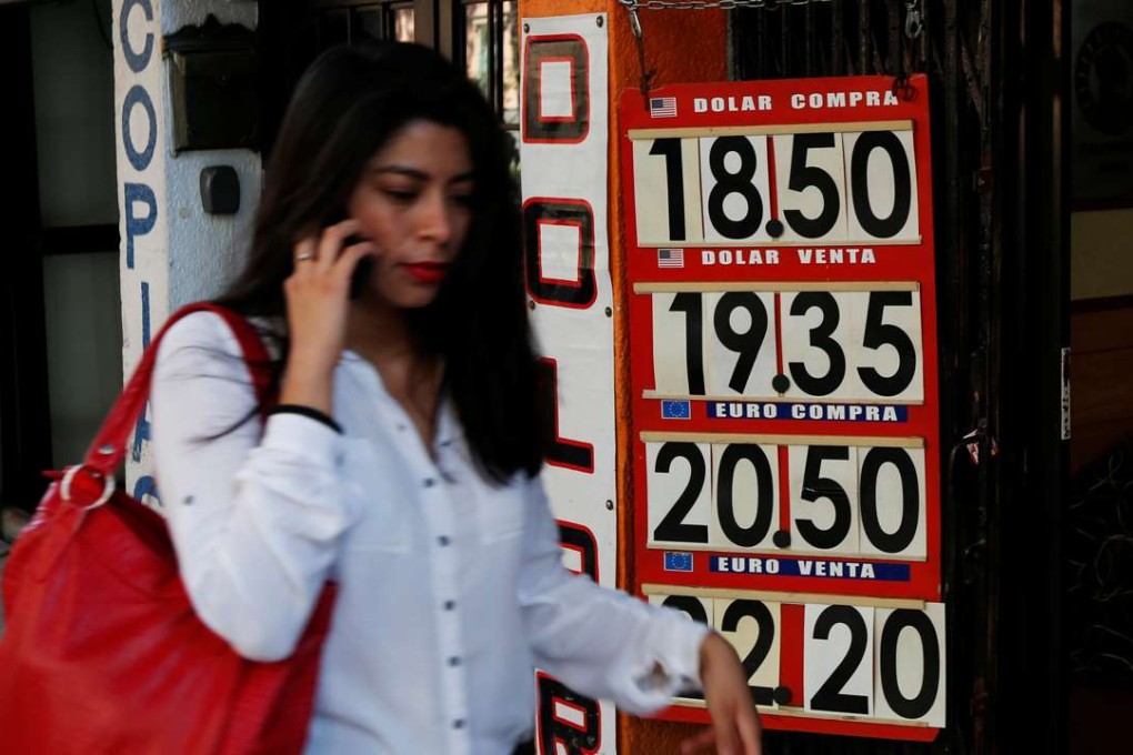 A board in Mexico City displays the exchange rates for the peso on March 1, 2017. Photo: Reuters