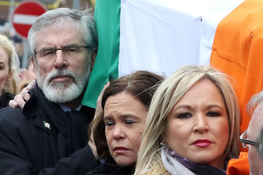 Sinn Fein President Gerry Adams (left), Sinn Fein Southern leader Mary Lou McDonald and Sinn Fein Northern Ireland Leader Michelle O'Neill (right) carry of former Northern Ireland Deputy First Minister Martin McGuinness in Derry, Northern Ireland on Thursday. Photo: AFP