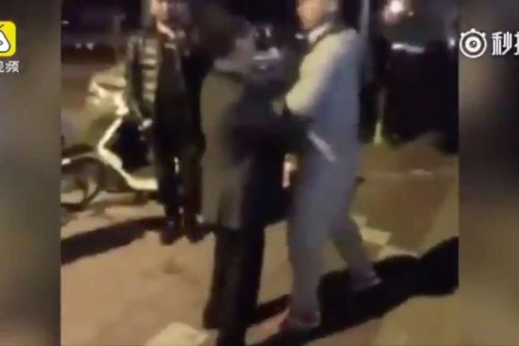 The two men squaring up to each other outside the police station in Shandong province. Photo: Handout