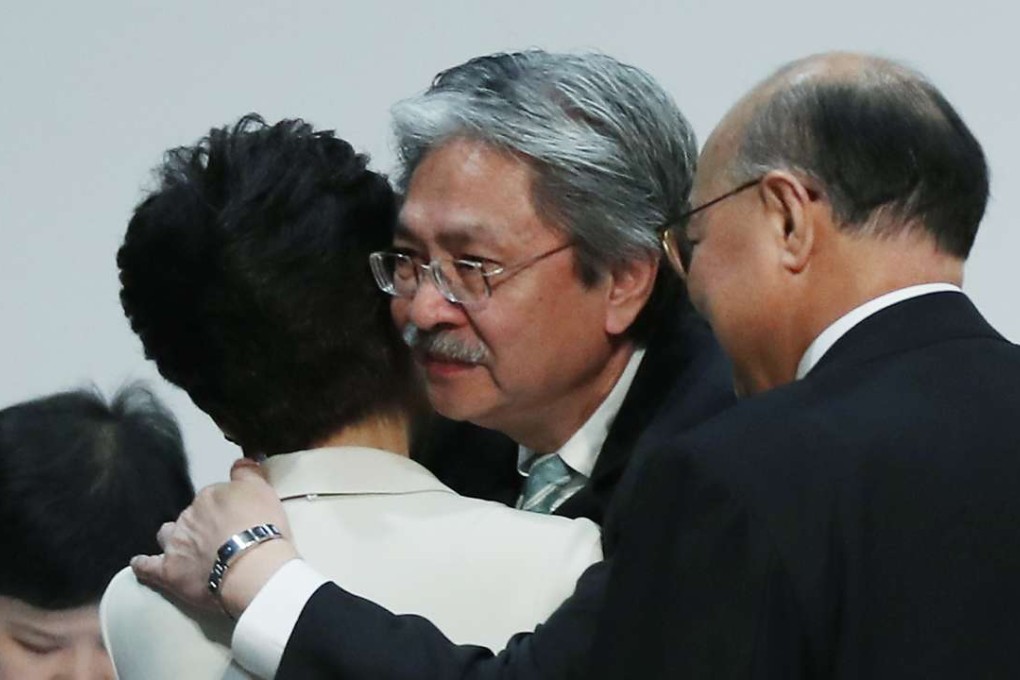 The three chief executive candidates embrace after the results are announced. Photo: Robert Ng
