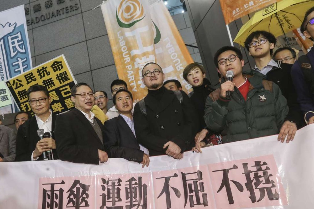 The nine Occupy movement activists outside Hong Kong police headquarters on Monday night. Photo: K. Y. Cheng