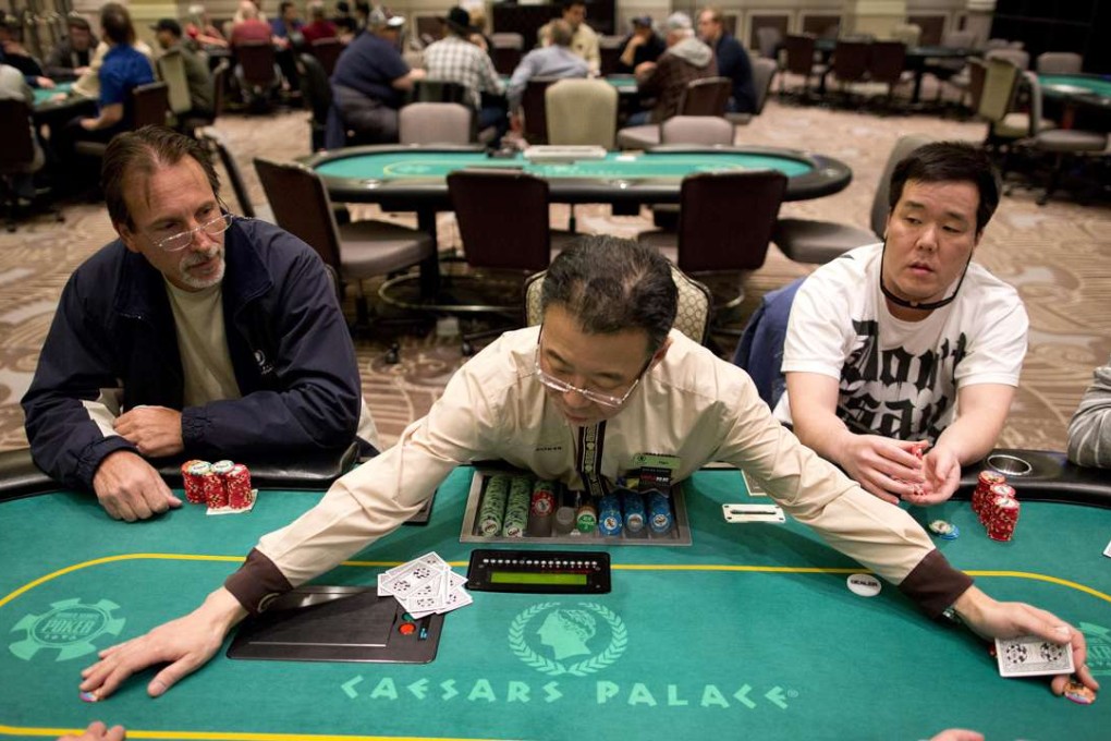 Croupier Han Kim gathers chips after a hand of Texas Hold 'em at a poker room in Caesar's Palace in Las Vegas. Photo: AP