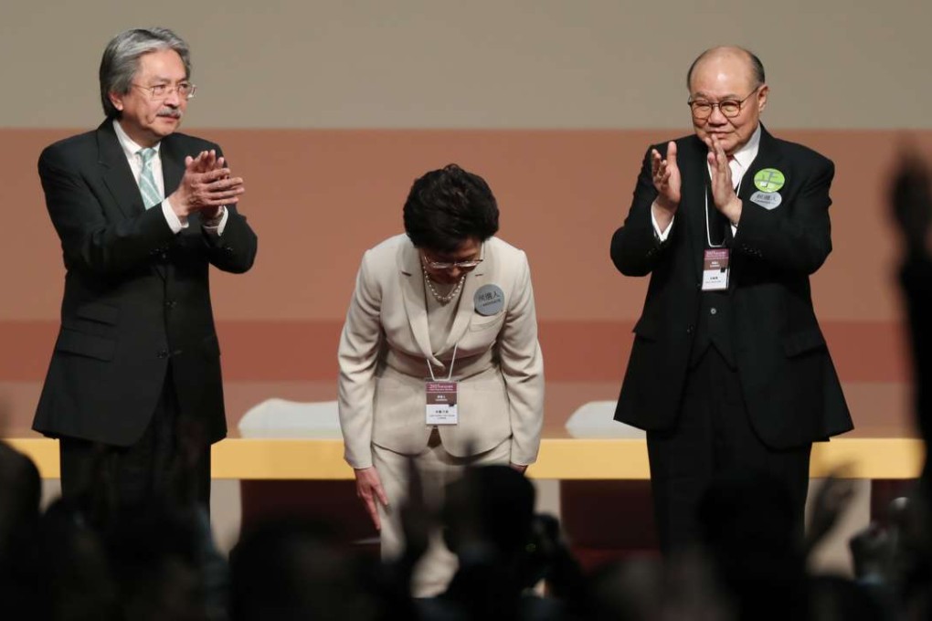 John Tsang Chun-wah, Carrie Lam Yuet-ngor and Woo Kwok-hing stand on stage during the announcement of the results. Photo: Robert Ng