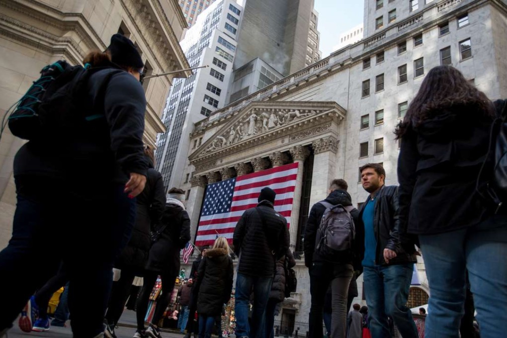 A file picture of pedestrians in Wall Street in front of the New York Stock Exchange . Photo: Bloomberg
