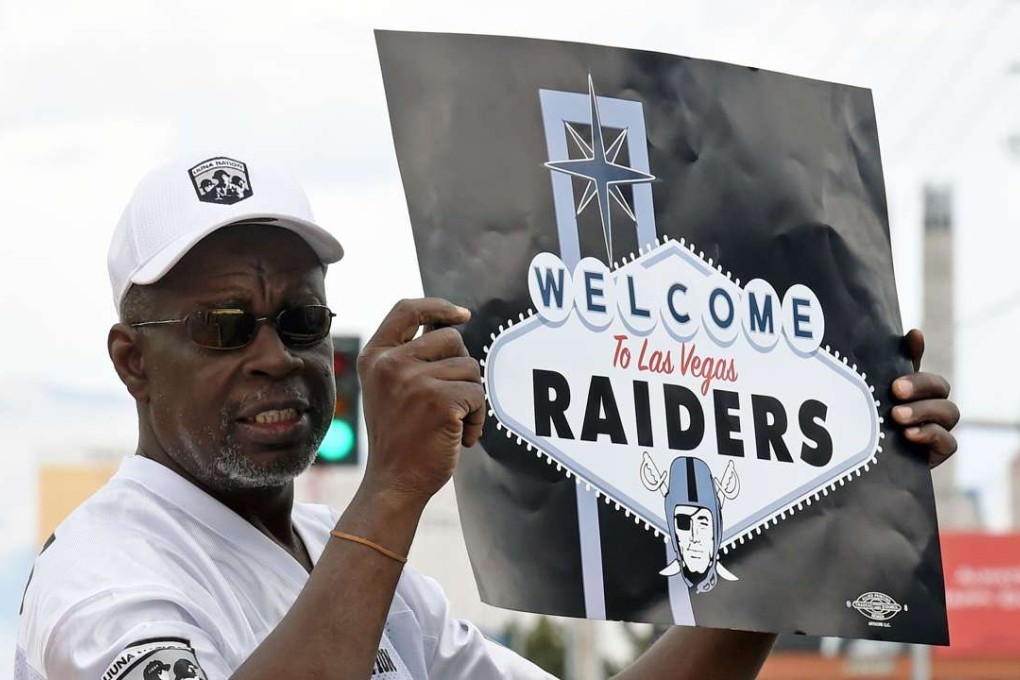 An Oakland Raiders fan displays a sign to passing motorists on the Las Vegas Strip near the ‘Welcome to Fabulous Las Vegas’ sign after NFL owners voted to approve the relocation. Photo: AFP