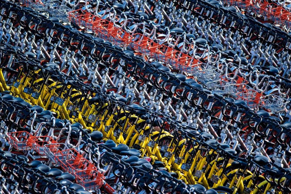 There are up to 30 smartphone-based bicycle sharing applications competing for market share in China. The business of bike sharing is dominated by two competing apps in the Chinese capital, between the orange-spoked Mobike and the yellow frame Ofo. Photo: AFP