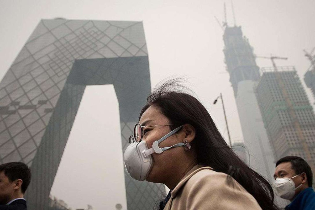 A woman wearing a protective pollution mask walks on a street in Beijing. Photo: AFP